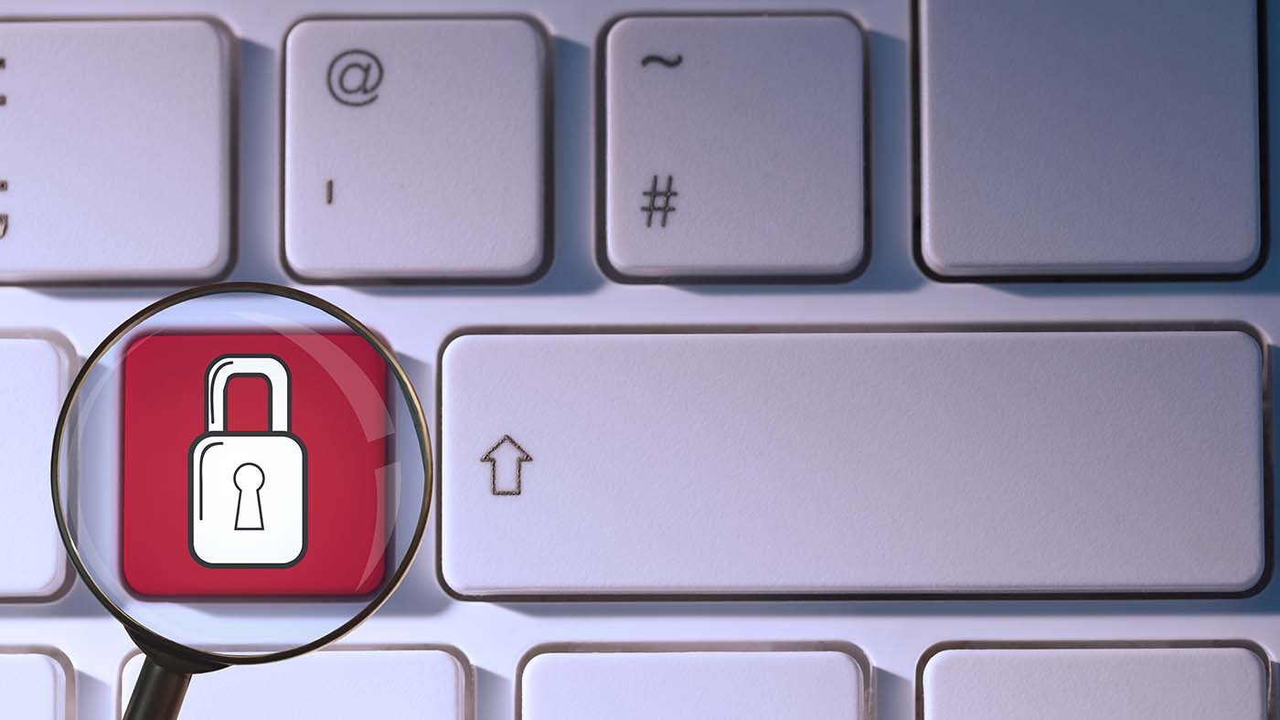 composite of padlock symbol on keyboard with magnifying glass